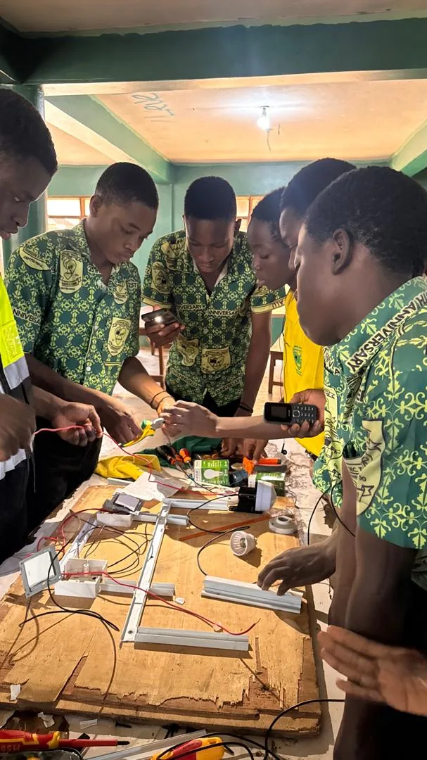 A team of Action SHTS students wiring a lighting circuit together on a practice board